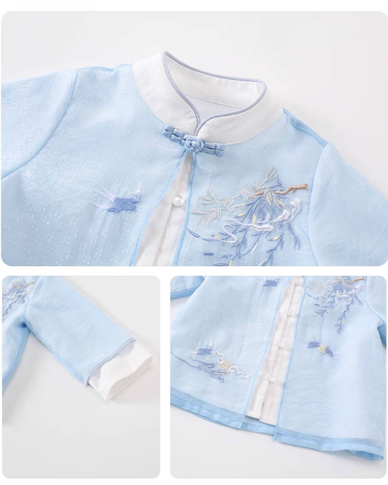 Light blue traditional outfit with white embroidery on a white background