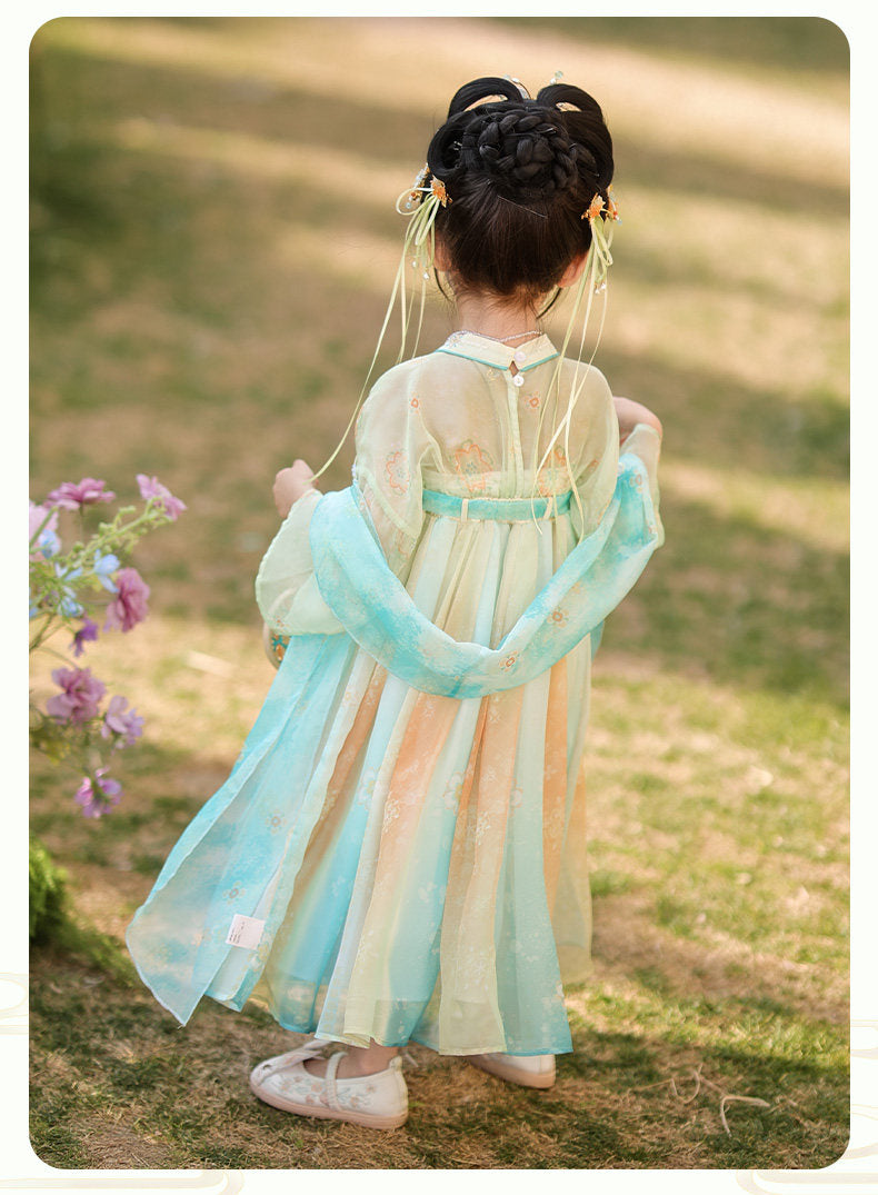 Child wearing a traditional outfit with a blurred natural background