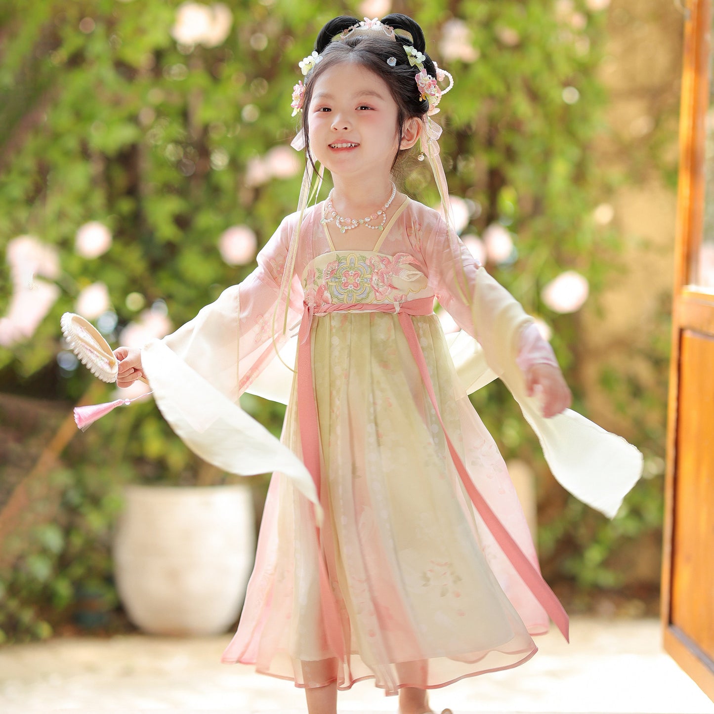 Young girl in a traditional outfit with a blurred natural background