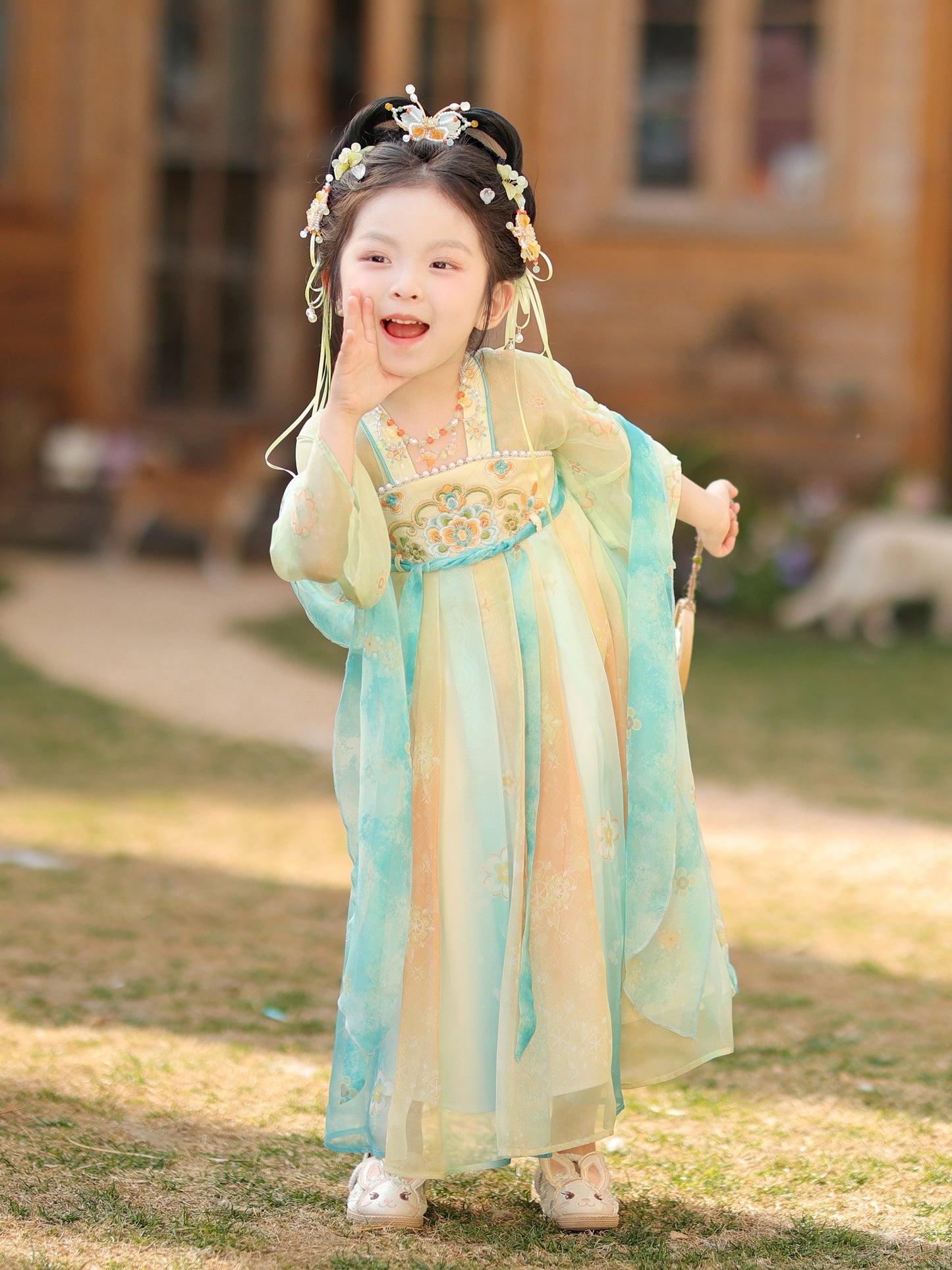 Child in traditional outfit with floral headpiece outdoors