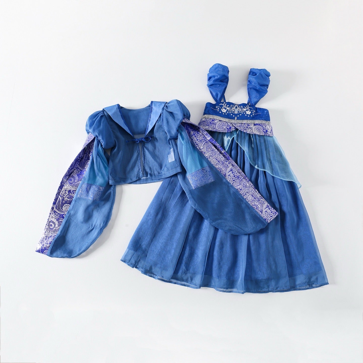 Blue children's dress with matching cape on a white background