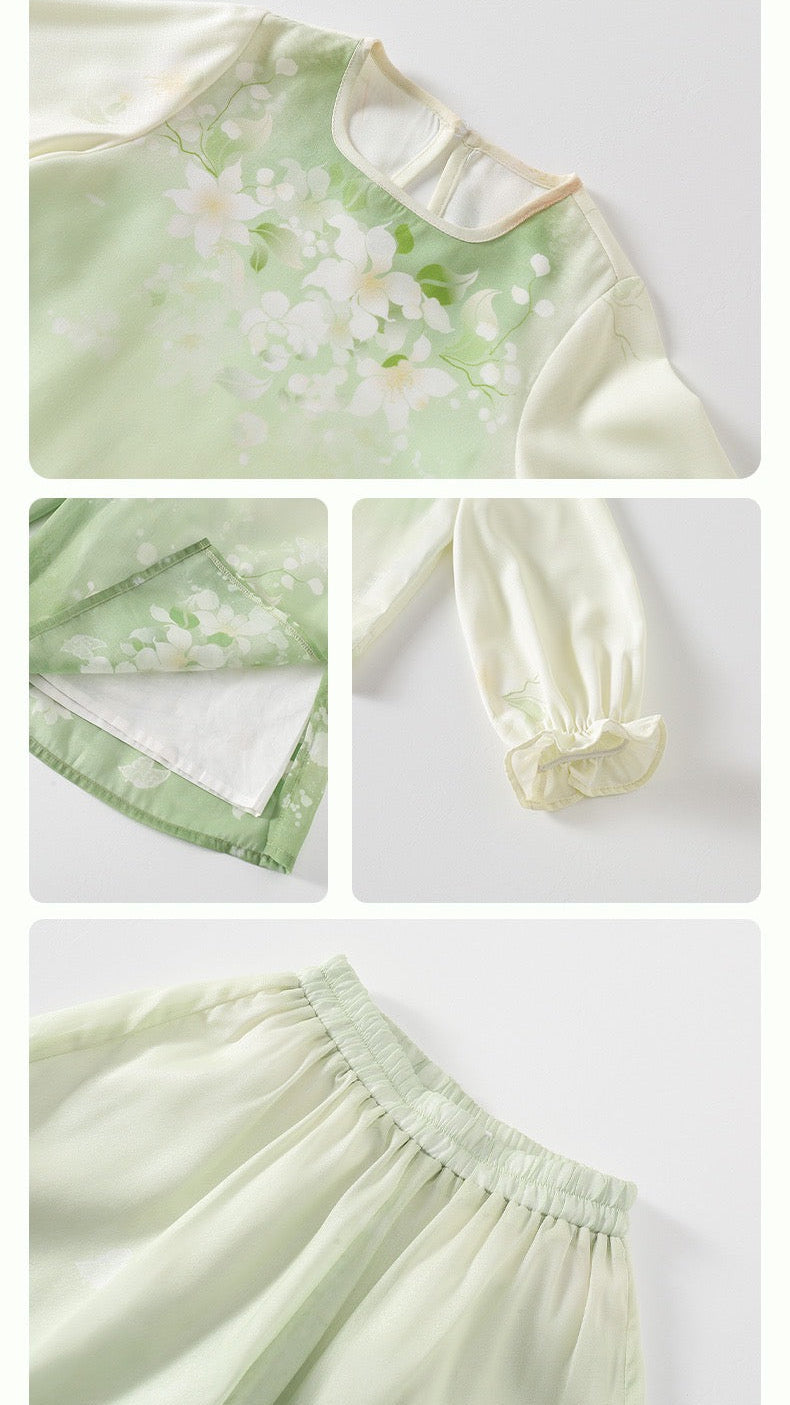 Green dress with floral patterns on a light gray background