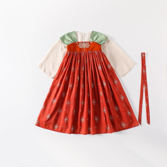 Traditional outfit with a red skirt and green top on a white background
