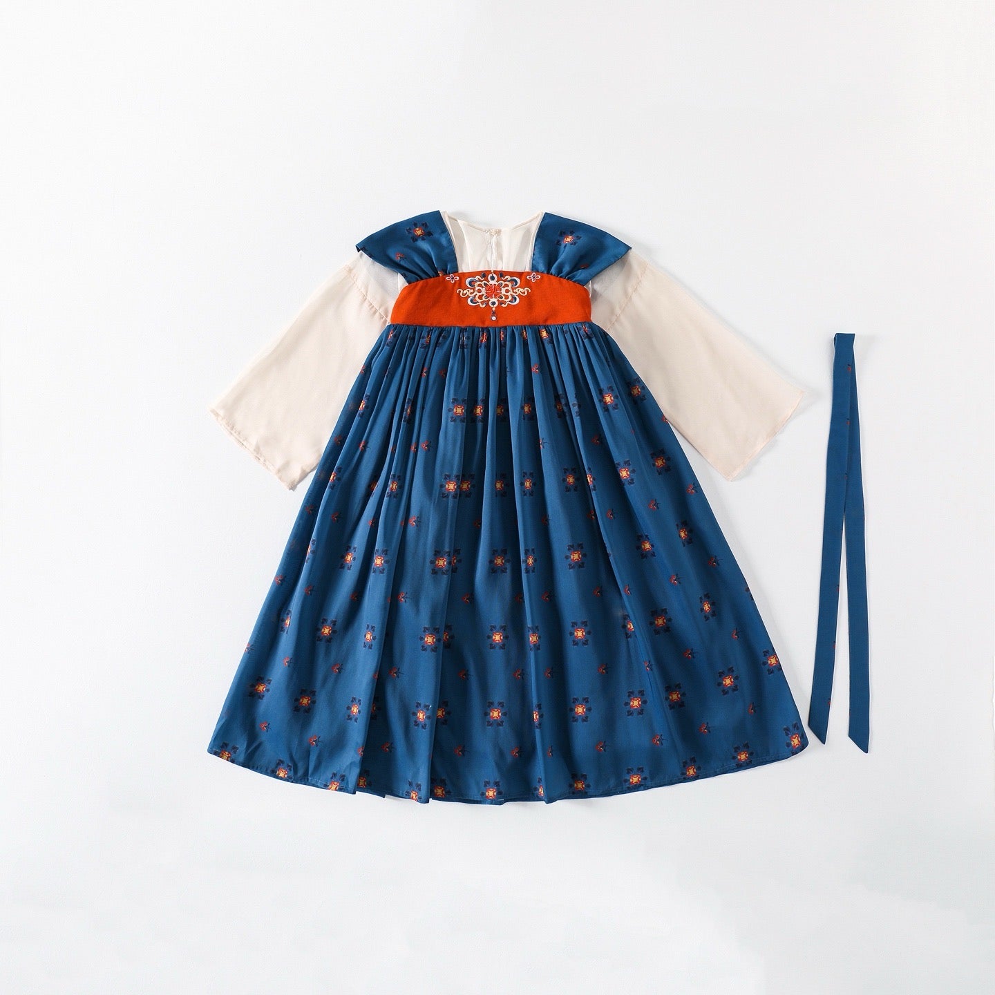Blue dress with orange belt and white sleeves on a white background