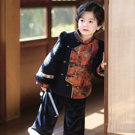 Child in traditional attire standing in a room with wooden flooring and large windows.