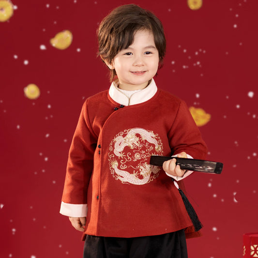 Child wearing a traditional outfit with a red background
