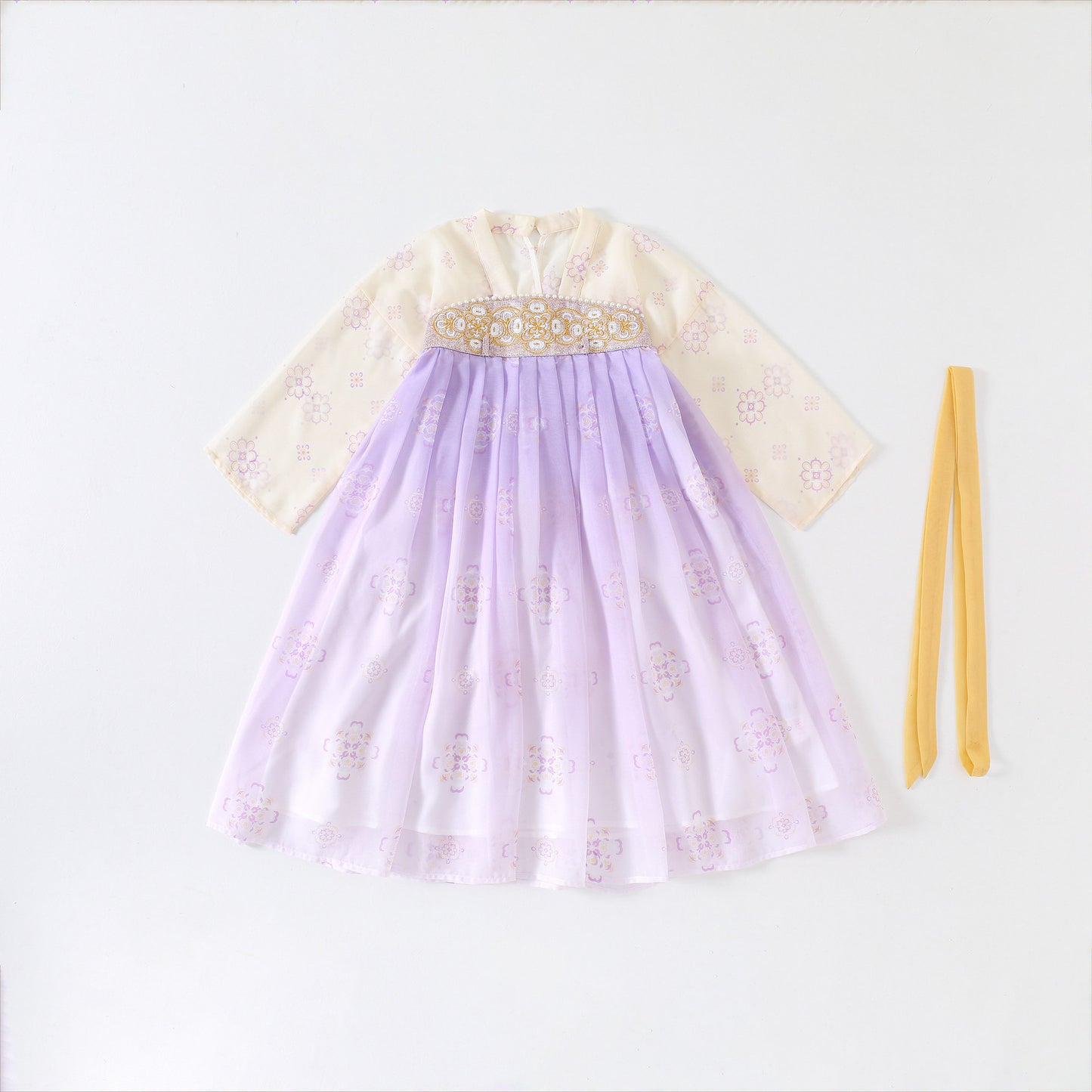 Traditional outfit with a light purple skirt and cream top on a white background