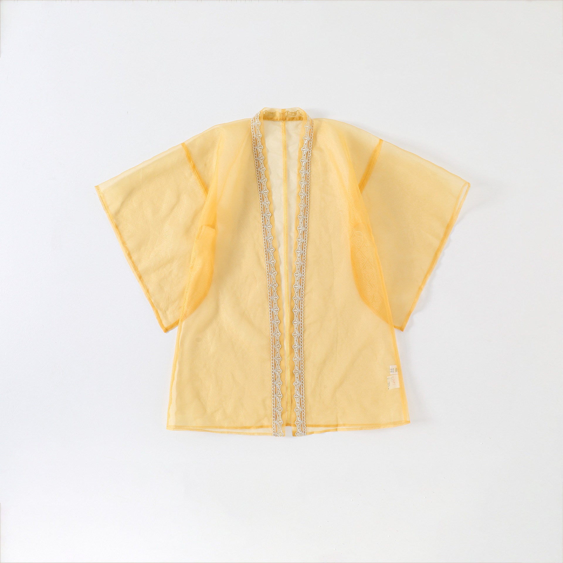 Yellow garment with decorative trim on a white background